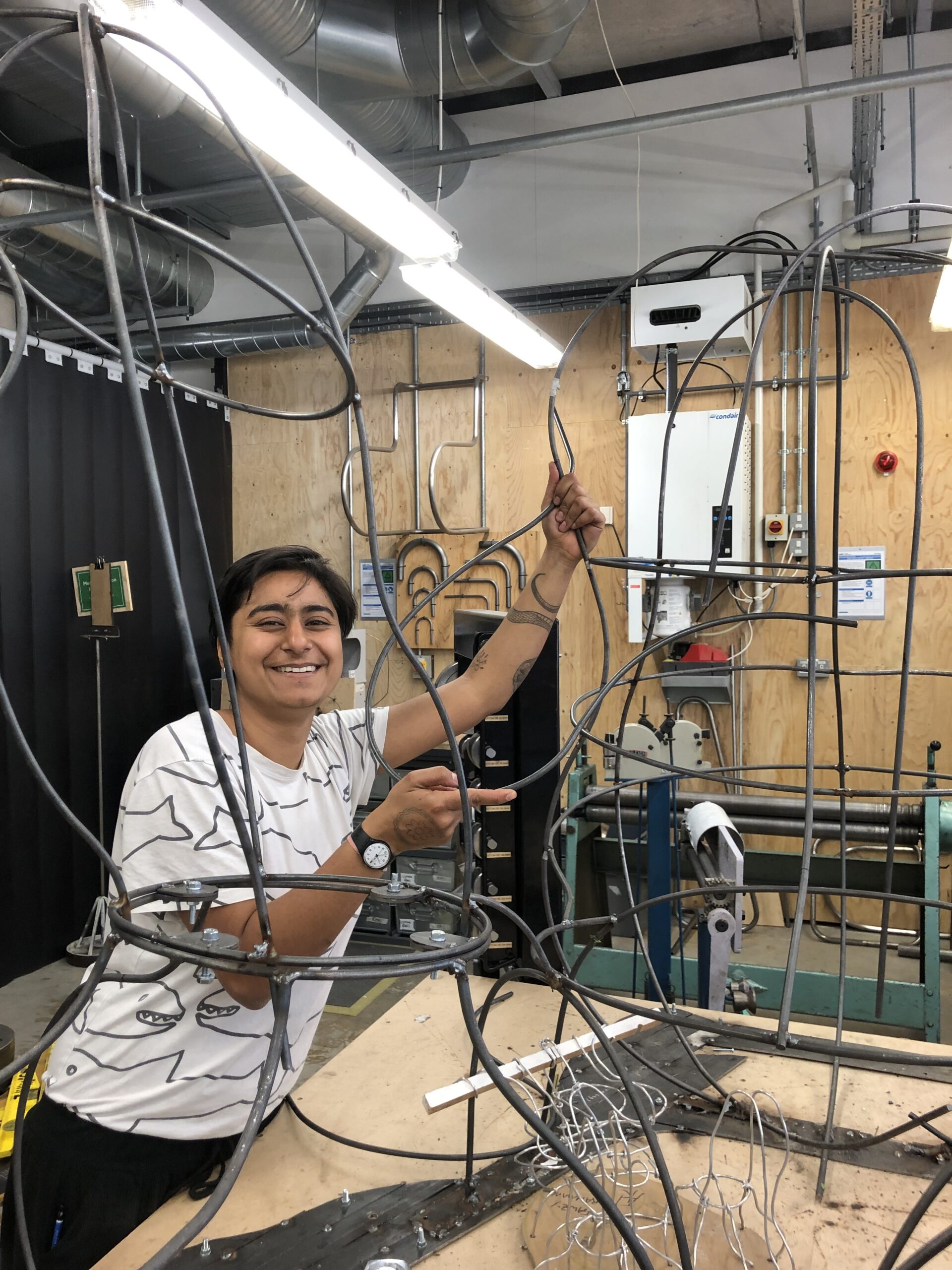 one of our makers in residence with a metal piece they made